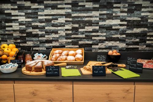 a buffet with bread and other foods on a table at Agriturismo Val Castel in Sporminore