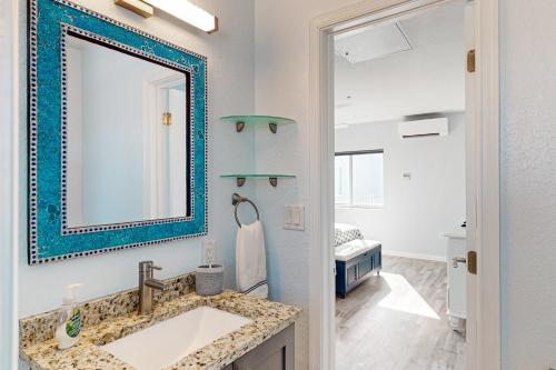 a bathroom with a sink and a mirror at Ocean Isles #28 in Marathon