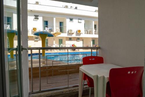 a view of a pool from a room with a table and chairs at Shangrilá - Rede Soberano in Porto Seguro