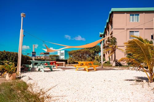 a picnic area with picnic tables and a building at Suite F201 @ Mara Laguna in San Pedro