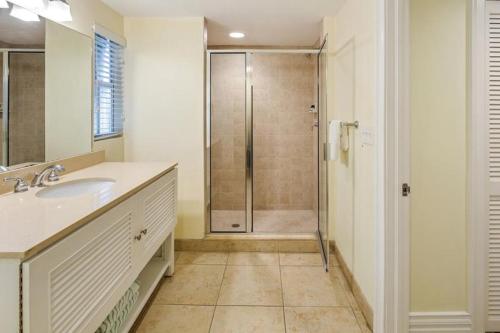 a bathroom with a shower and a sink and a shower at Coconut Beach Resort in Key West