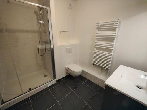 a bathroom with a shower and a toilet and a sink at Le clos d'Asnières in Asnières-sur-Seine