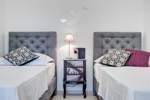 a bedroom with two beds and a table with a lamp at Apartment Melki in Split