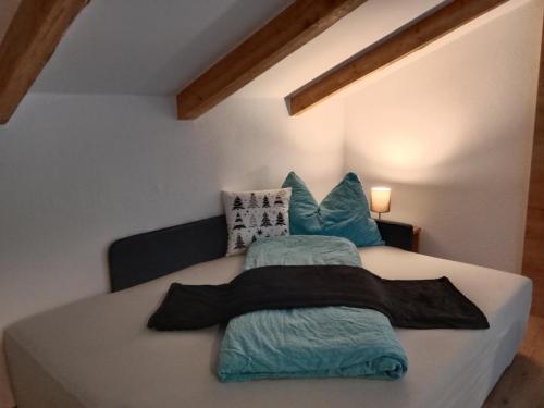 a bedroom with a bed with pillows on it at Ferienhaus Haueis in Tumpen