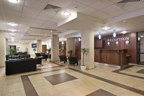 a hotel lobby with a reception desk and chairs at Apartment B45 Borovets Gardans in Borovets