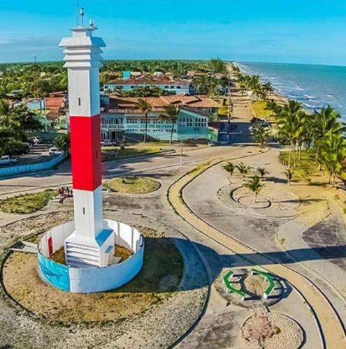 an aerial view of a lighthouse in front of the ocean at Hotel Convés do Farol in Alcobaça