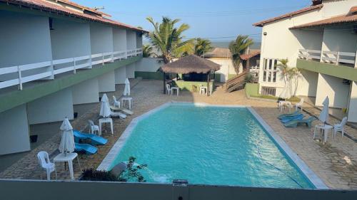 a swimming pool in front of a hotel at Hotel Convés do Farol in Alcobaça