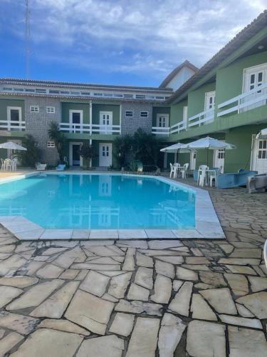 a large swimming pool in front of a building at Hotel Convés do Farol in Alcobaça