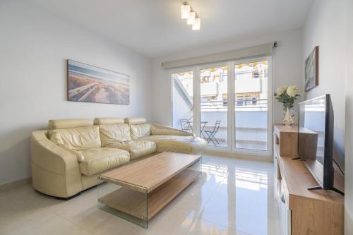 ein Wohnzimmer mit einem Sofa und einem Couchtisch in der Unterkunft Apartamentos Castillo in Fuengirola