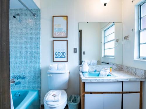 een badkamer met een wastafel, een toilet en een bad bij Bollinger Duplex Both Sides in Holmes Beach