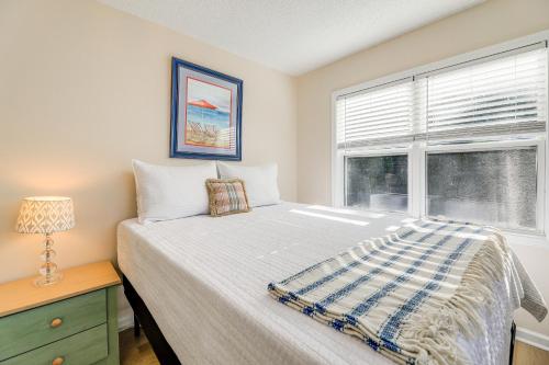 a bedroom with a bed and a window at Well-Equipped Emerald Isle Townhome Pets Welcome! in Emerald Isle