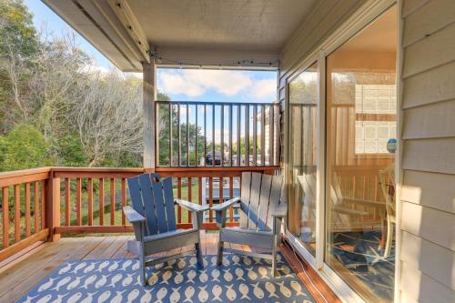 two chairs sitting on a screened in porch with a view at Well-Equipped Emerald Isle Townhome Pets Welcome! in Emerald Isle