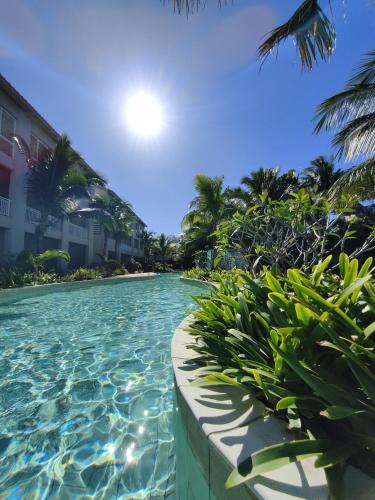a pool at a resort with palm trees at Apartment in a Tropical Oasis, Ki Residences, Pereybere - Managed by KSN in Pereybere