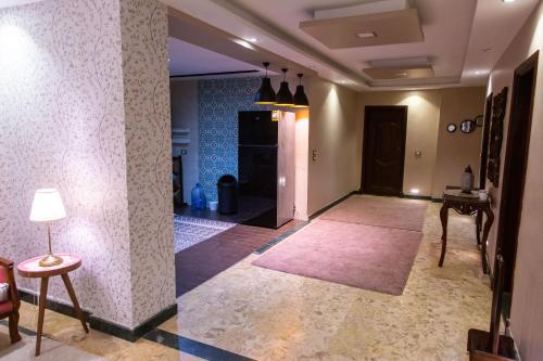a hallway with a living room with a rug at Cairo Heliopolis Apartment in Cairo