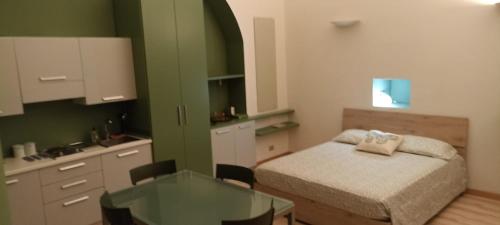 a small room with a bed and a table at L’angolo infinito in Turin
