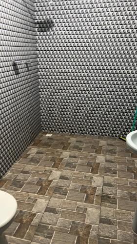 a bathroom with two sinks and a tiled floor at Condomínio luiza in Rio Branco