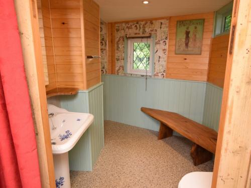 a bathroom with a sink and a bench in it at 1 Bed in Bodiam 51574 in Bodiam