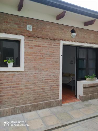 a brick wall with a door and a patio at La Estación Departamento in Concepción del Uruguay