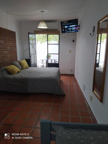 a bedroom with a bed and a tiled floor at La Estación Departamento in Concepción del Uruguay