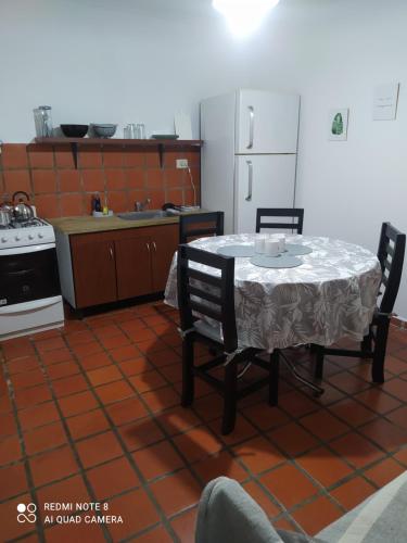 a kitchen with a table and chairs and a refrigerator at La Estación Departamento in Concepción del Uruguay