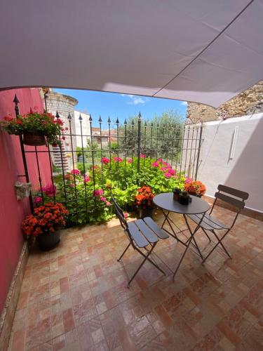 a patio with a table and chairs and flowers at PianoB&b in Campobasso