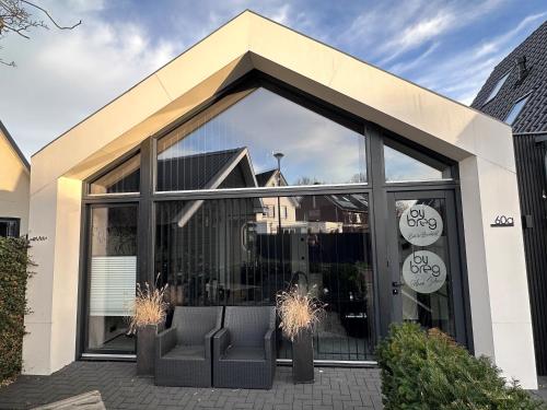 a building with a large window with chairs in it at te gast ByBreg in Apeldoorn
