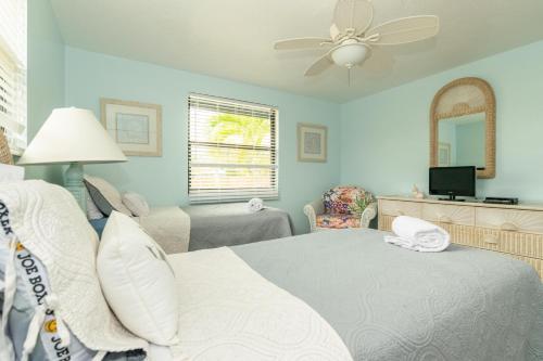 a bedroom with a bed and a living room at Azure Seas in Anna Maria