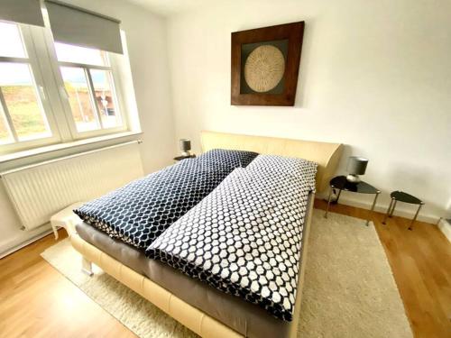 a bedroom with a bed with a blue and white blanket at Schöne Wohnung im Herzen von Miltenberg in Miltenberg