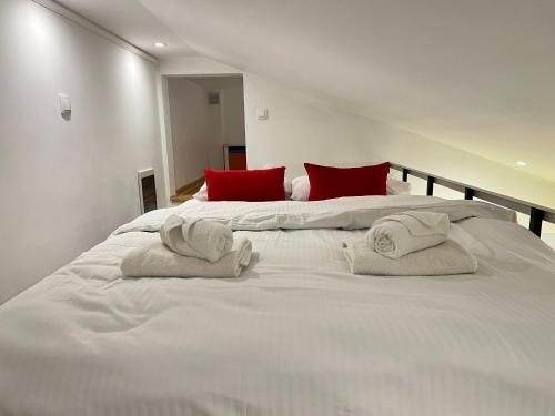a large white bed with towels on top of it at Silicon Valley studio in Belgrade