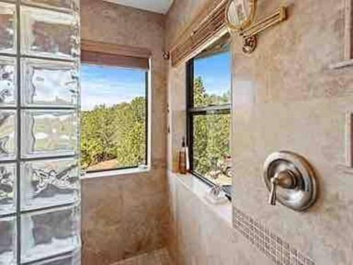 a bathroom with a shower and a window at Uptown Cabin Home with Views HotTub near Trails in Sedona