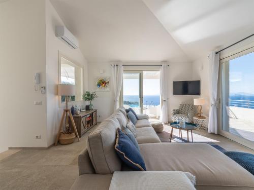 a living room with a couch and a tv at Villa Serenity in Terra Mala