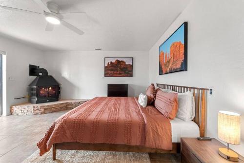 a bedroom with a bed and a fireplace at Luxury Uptown home with Views and Hot Tub in Sedona