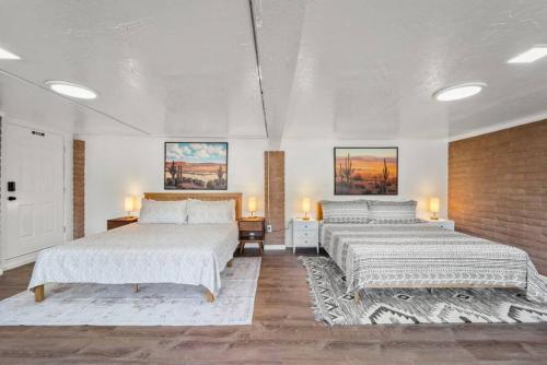 Un dormitorio con dos camas y una pared de ladrillo. en Luxury Uptown home with Epic Views and Hot Tub, en Sedona