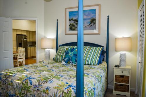 a bedroom with a bed with a blue canopy at Lakeside Beach House in Holmes Beach