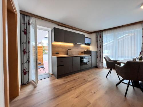 a kitchen and dining room with a table and chairs at Appart Kofler in Gerlos