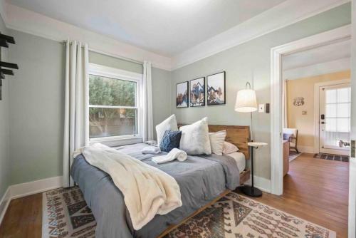 a bedroom with a bed and a window at Stylish and Cozy Downtown 2 Bedroom Unit with Hot Tub in Flagstaff
