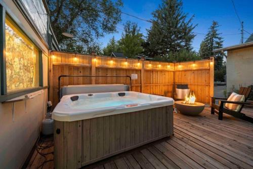 a hot tub on a wooden deck with a fence at Desert Modern Downtown Flagstaff Unit with Hot Tub in Flagstaff