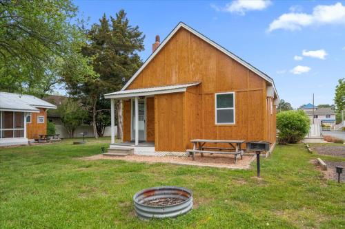 a wooden house with a fire pit in the yard at Beach Bum West-O Cabins in Ocean City