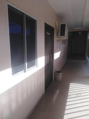 a hallway with a door and windows in a room at Marcopolo Hotel in Makurdu