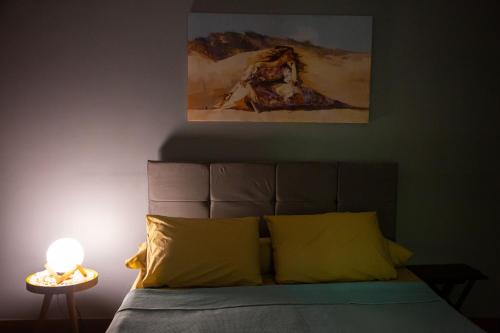 a bedroom with a bed with a painting on the wall at Cairo Heliopolis Apartment in Cairo