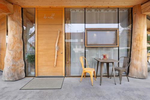 a table and chairs in front of a glass wall at Albchalet in Rosenfeld