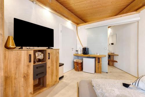 a living room with a flat screen tv on a wall at Albchalet in Rosenfeld