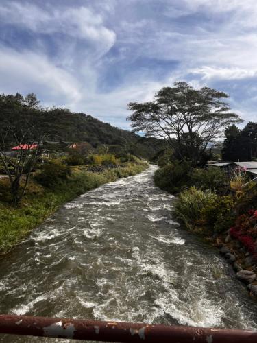 a river with rapids on the side of it at Boho by Arte Hostal Boquete in Bajo Boquete