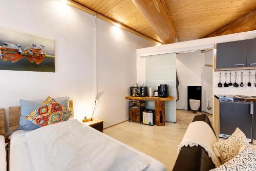 a room with a bed and a kitchen in it at Albchalet in Rosenfeld