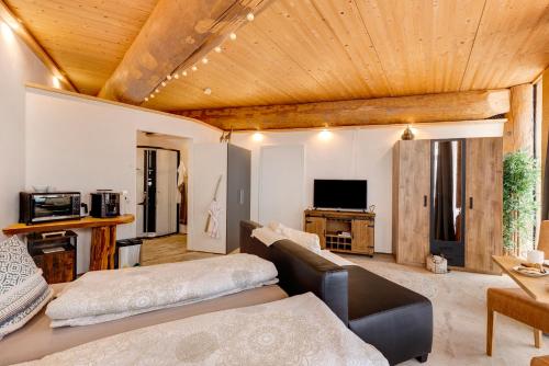 a living room with a couch and a tv at Albchalet in Rosenfeld