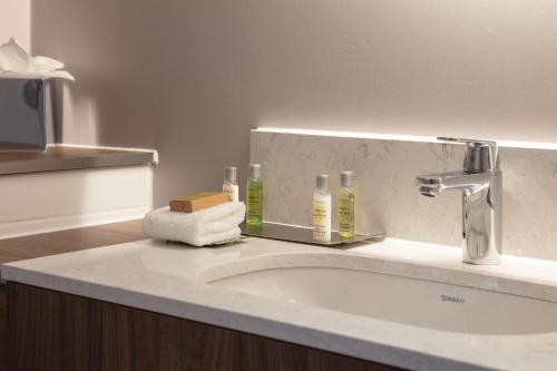 a bathroom counter with a sink and a mirror at DoubleTree by Hilton Edinburgh Airport in Ingliston