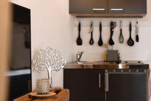 a kitchen with a table with a tree on the wall at Albchalet in Rosenfeld