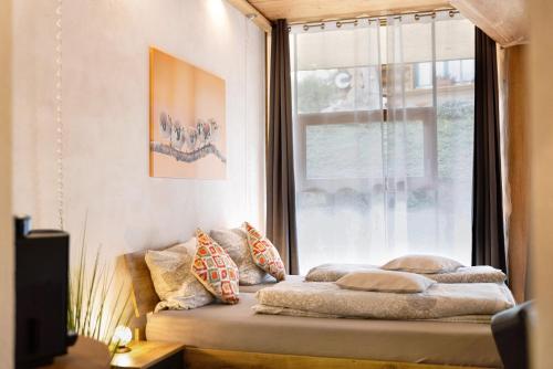 a bed sitting in a room with a window at Albchalet in Rosenfeld