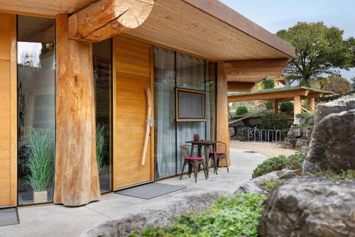 a house with glass doors and a table on a patio at Albchalet in Rosenfeld