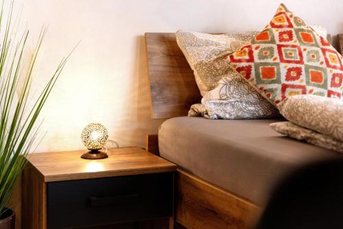 a bedroom with a bed with pillows and a night stand at Albchalet in Rosenfeld